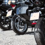 Motorcycle luxury items close-up: headlights, shock absorber, wheel, wing, toning.