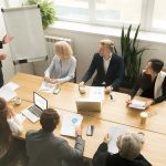 African american ceo giving presentation at corporate team meeti