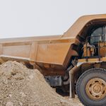 Male worker with bulldozer in sand quarry