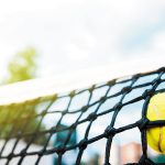 Close-up view of tennis ball in net