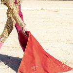 Picture of a bullfighter or matador in traditional clothes and red fabric